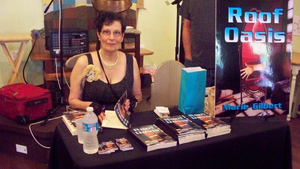 Gilbert signs copies of her book, 'Roof Oasis'. Credit: Marie Gilbert.