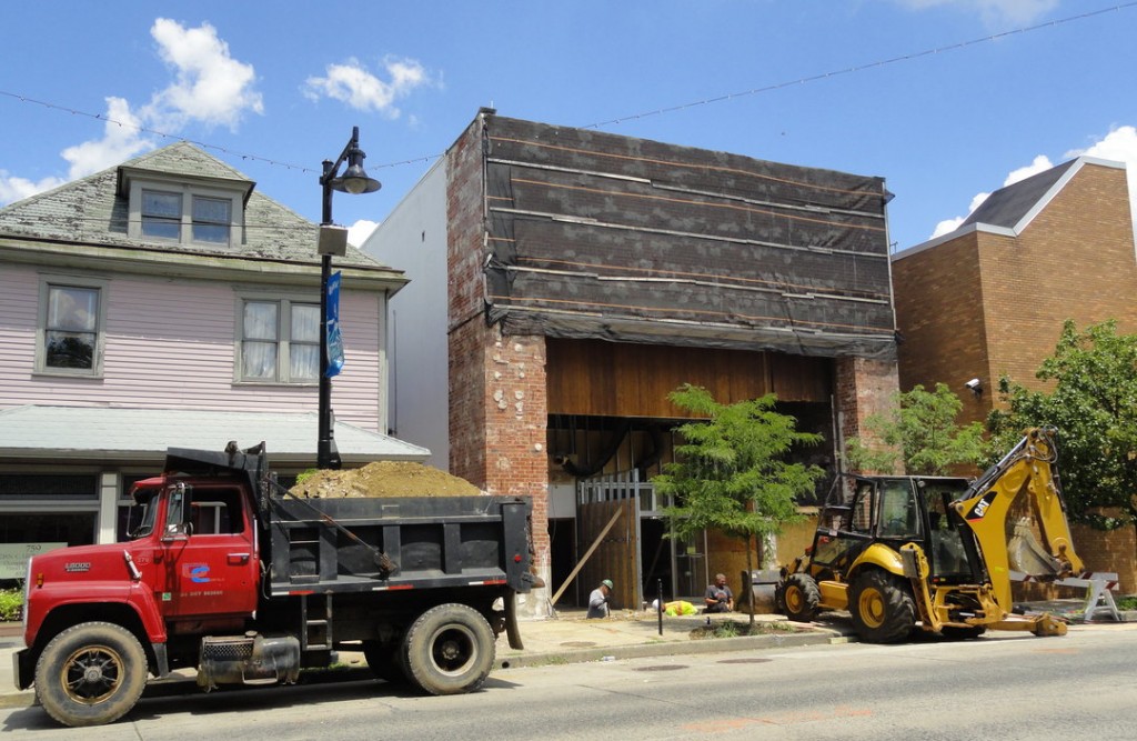 Construction vehicles help excavate and re-pour the foundation at the entrance to the DePace Sports Museum on Haddon Avenue in Collingswood. Credit: Matt Skoufalos.