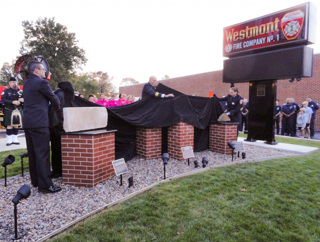 Gallagher, Voigtsburger, and Hauber unveil the Westmont Fire Company's 9-11 Memorial. Credit: Matt Skoufalos.