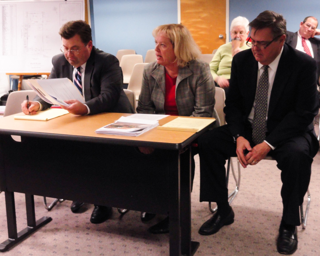 Burgess (right) and Stevens (seated, to his left), present their plans for McFarlan's Market. Credit: Matt Skoufalos.