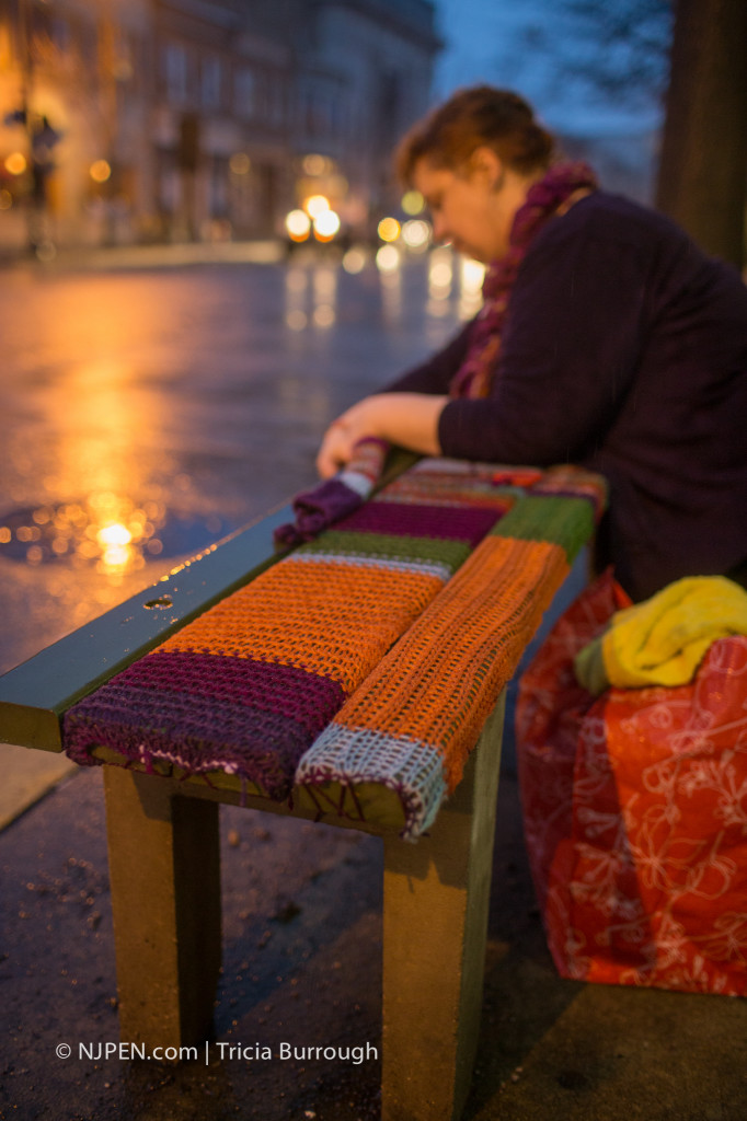 Elspeth Abel Slater affixes her yarnbomb to a bench in Collingswood. Credit: Tricia Burrough.