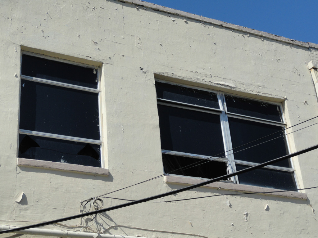 Exterior of "The Rooftop Lounge" with visible damage. Credit: Matt Skoufalos.