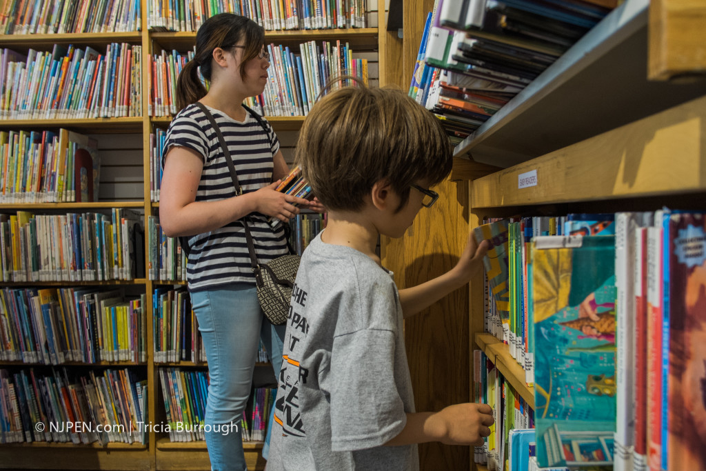 Yuka Kobe and Luca Dicello check out books. Credit: Tricia Burrough.