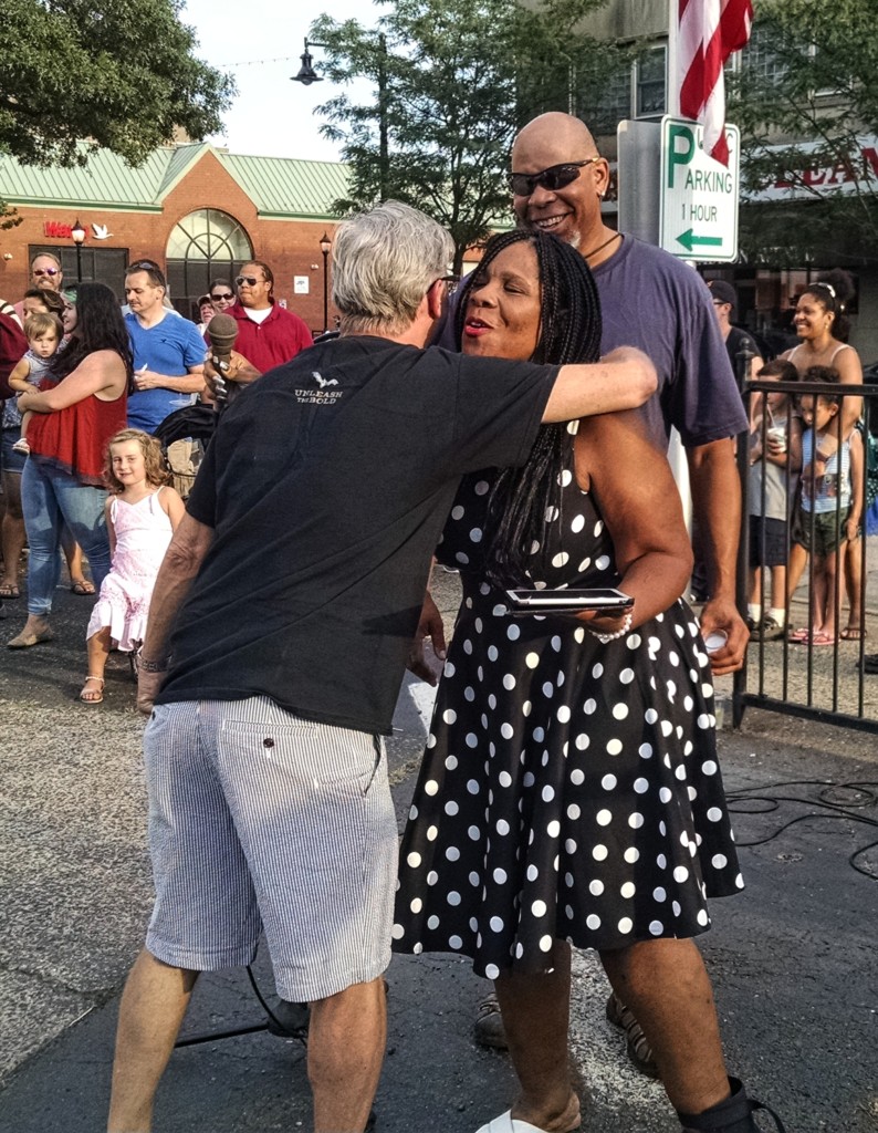 Stephne Coney gets a hug from an attendee at Friday's peace vigil. Credit: Matt Skoufalos.