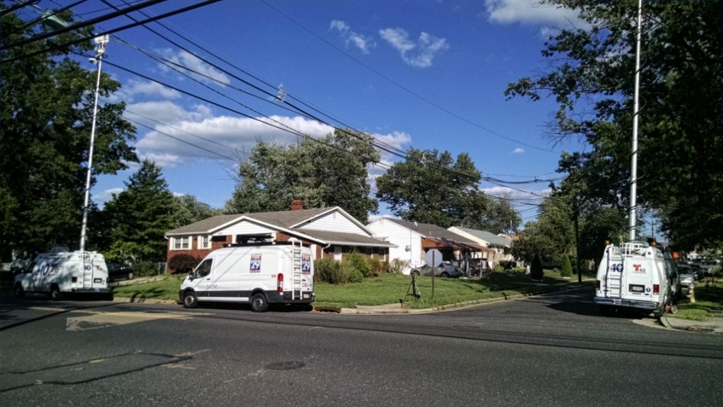 News crews line Mansion Boulevard in Pennsauken, where police said a toddler was beaten to death Saturday. Credit: Matt Skoufalos.